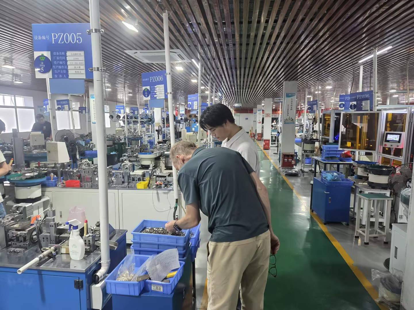 Norway customer visit connector factory - customer watching pin header assembly machine